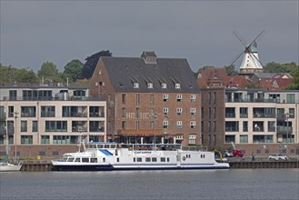 View of the harbour from the garden of the youth hostel, excursion boat, houses, Amanda windmill,