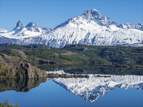 The snow-covered Mt. Cerro Castillo is reflected in a lake, Patagonia, Chile, South America