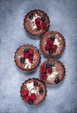 Chocolate tartlets, stuffed with cottage cheese and berries, breakfast, homemade, no people