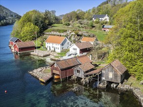 Typical red and white wooden norwegian house, near Cape Lindesnes at the Lenefjord, Norway, Europe