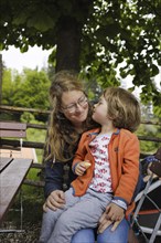 Mother has a four-year-old child on her lap, Murnau, 19.05.2023