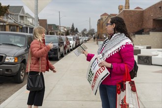 Hamtramck, Michigan USA, 27 February 2024, Lindsey Matson urges people arriving to vote in