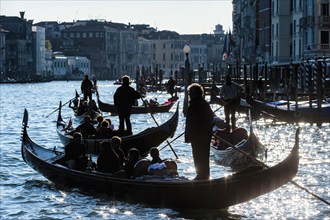 Gondola and jetty against the light on the Grand Canal, city trip, holiday, travel, tourism, lagoon