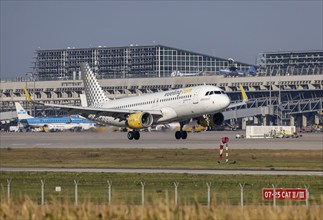 Stuttgart Airport with terminal, aircraft of the airline Vueling landing. Stuttgart,