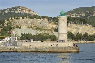 Lighthouse and people, houses on rocks on the shore, Mediterranean coast, bay, mountains, Cassis,