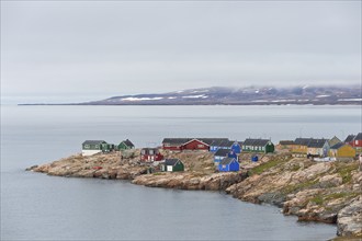 Colourful houses on a rocky coastal landscape, remote Arctic Inuit settlement Ittoqqortoormiit,