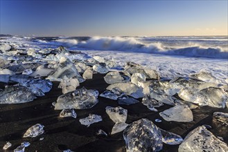 Ice floes on the beach, waves, sea, sunny, morning light, winter, Diamond Beach,