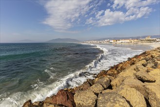 Rocky beach with waves crashing against the coast under a clear sky, Tarifa