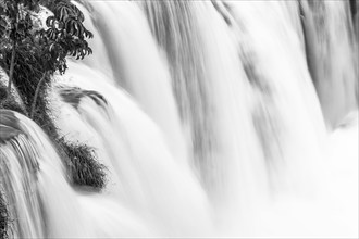 B&W landscape photo of falling water over the edge of the water fall. Long exposure image of