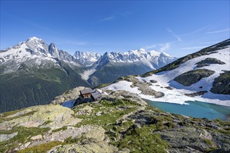 Mountain landscape with mountain lake Lac Blanc and mountain hut Refuge du Lac Blanc, mountain