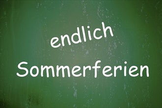 Symbolic image summer holidays: The word ENDLICH SOMMERFERIEN is written on a school blackboard