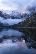 The Vordere Gosausee lake in autumn with a view of the Dachstein mountain range. The Gosaukamm on