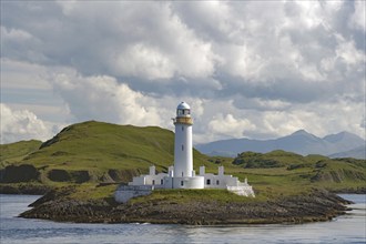 White lighthouse on a barren, green island, high mountains, Stevenson family, Lismore Lighthouse,