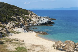 Lonely coastal landscape with clear water, rocky shores and a quiet beach under a blue sky, beach,