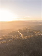 Sunrise over a hilly forest landscape during the golden hour, Black Forest, Germany, Europe