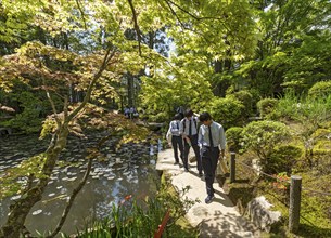 Japanese school children in uniforms visit the Tenjuan Garden, Nanzen-ji temple complex, Kyoto,