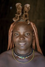 Himba woman in her hut, portrait, Ohandungu, Kunene region, Kaokoveld, Namibia, Africa