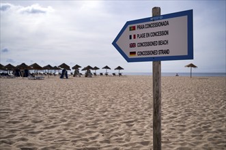 Sandy beach beach sign, guarded, concession beach, multilingual, Portuguese, French, English,