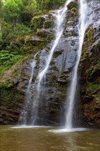 Waterfall inside the dense vegetation of rainforest among the rocks and vegetation in the state of