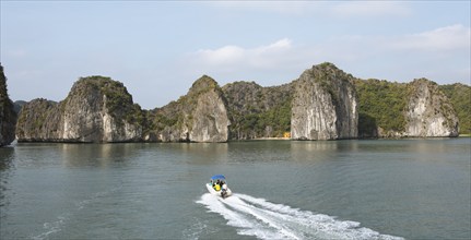 Excursion boat and the karst rocks in Lan Ha Bay, Halong Bay, Vietnam, Asia