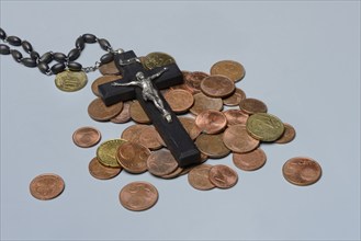 Crucifix and coins, euro coins, Church and money