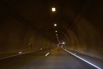 Motorway tunnel A71 with illuminated road and modern light installations offering a perspective