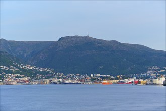 City view on the coast, harbour with Bergen in the background and calm water in the foreground,