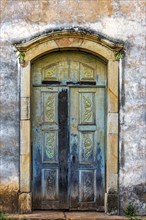 Carved wooden door in an old baroque church in the city of Ouro Preto in Minas Gerais