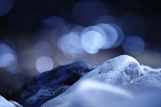 Stones on the bank of a stream with beautiful bokeh, Germany, Europe