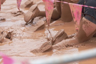 Shoes in the mud during a dynamic outdoor obstacle course