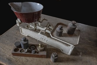 Old scales with weights in a former corn mill, Bavaria, Germany, Europe