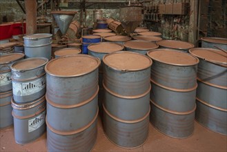 Metal drums for metal powder in the bronze powder filling room of a metal powder mill, founded in