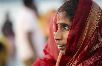 Hindu devotees perform rituals as they offer prayers to the Sun god in the bank of Brahmaputra