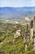 Hermitages between high rocks, monasteries on sandstone formations, Meteora Trail, blue sky, spring