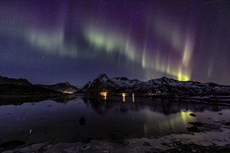 Northern lights over fjord, steep mountains, winter, aurora borealis, Flakstadoya, Lofoten, Norway,