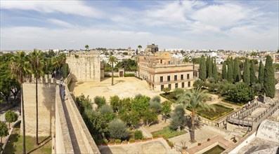 Historic buildings with a wall and gardens under a clear sky, Jerez