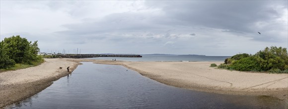 Wide beach with shallow waters and cloudy skies, Ballycastle