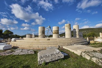 Round ruins with columns under a cloudy sky, Ancient Temple, Epidaurus, Peloponnese, Greece, Europe