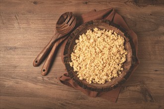 Cooked couscous, in a wooden bowl, top view, no people