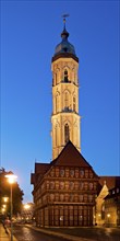 Old scales, detailed reconstruction with the illuminated St Andrew's Church in the evening,