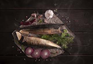 Smoked mackerel, top view, with spices, on a wooden table, no people, selective focus