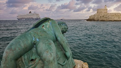 A damaged sculpture looks out over the sea and a fortress during a dramatic sunset, sky exchanged,