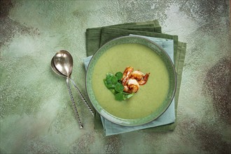 Pea cream soup, with shrimp, green soup, homemade, top view, no people