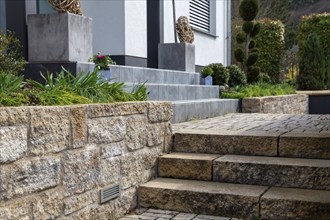 Well-kept front garden with block steps made of natural stone and granite