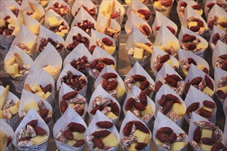 Cheese and small sausages packed for sale, Mercado San Miguel market, Madrid city centre, Spain,