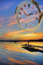 Symbol photo, clock, time, clock face, time, season, sunset, lake, landscape, sensation, sense of