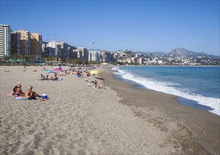 Playa de Malaguera sandy beach people sunbathing by the sea, Malaga, Spain, Europe