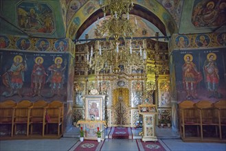 Interior view of an Orthodox church with richly decorated iconostasis and murals, Cheia Romanian