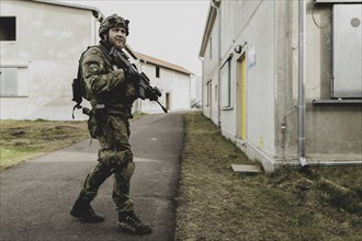 A soldier moves during a simulated house-to-house battle, taken as part of a Bundeswehr exercise