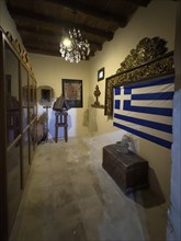 Chamber room with festive chandelier chandelier right Greek national flag flag of Greece in